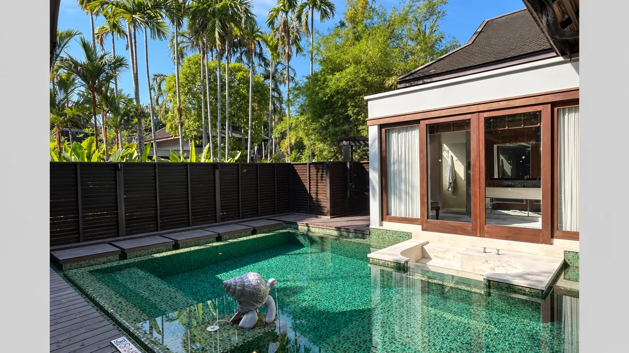 Private villa and plunge pool at Anantara Mai Khao Villas, with a privacy fence and palms beyond.